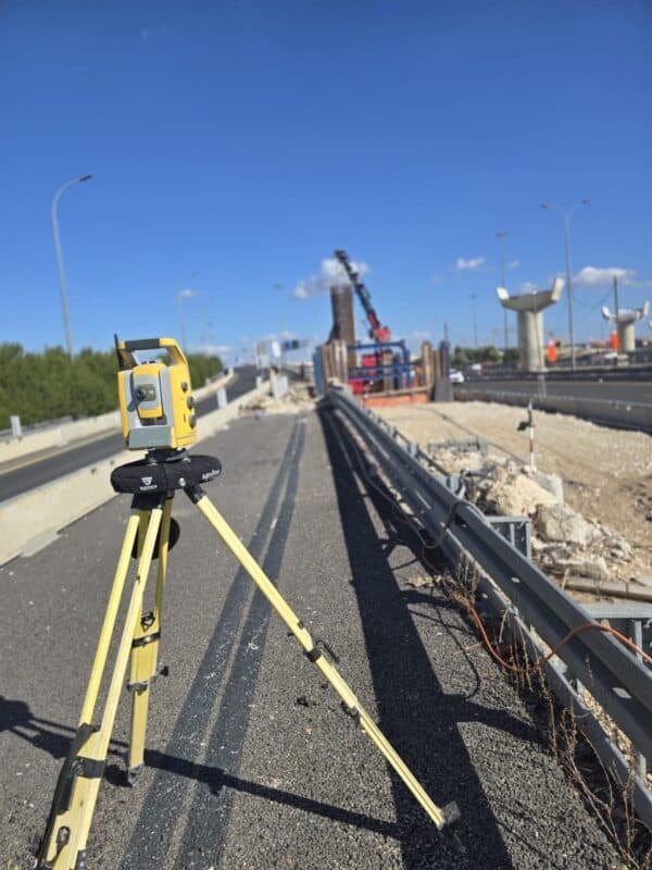 Surveyor with MiniPro-protected total station at a construction site